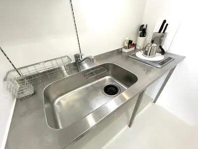 a stainless steel sink in a small kitchen at 彩光堂Village KAME101&202 in Tokyo