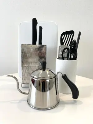 a tea pot and utensils in a holder on a table at 彩光堂Village KAME101&202 in Tokyo