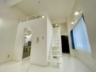 a white staircase in a white room with a window at 彩光堂Village KAME101&202 in Tokyo