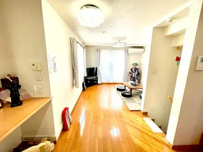 a living room with a hard wood floor and a person in the window at \u5409\u5409\u306e\u5bb6 in Tokyo