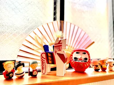 a group of figurines sitting on a window sill at \u5409\u5409\u306e\u5bb6 in Tokyo