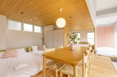 a room with a dining table and two beds at Hotel Re:ONcE Shibuya in Tokyo