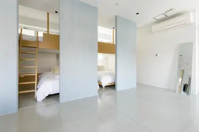 a bedroom with white walls and a bed in it at Hotel Re:ONcE Shibuya in Tokyo
