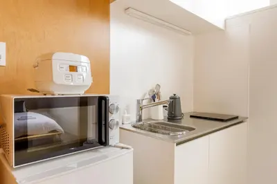 a microwave oven sitting on top of a kitchen counter at Hotel Re:ONcE Shibuya in Tokyo