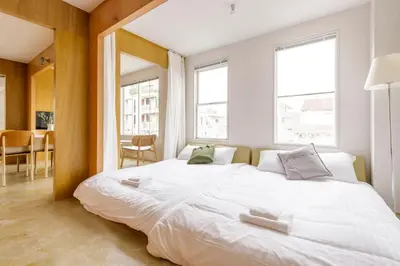 a large white bed in a room with windows at Hotel Re:ONcE Shibuya in Tokyo