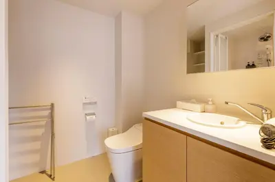 a bathroom with a toilet and a sink and a mirror at Hotel Re:ONcE Shibuya in Tokyo