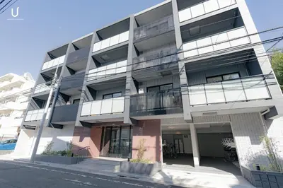 an apartment building with balconies on a street at unito residence HIKAWADAI in Tokyo