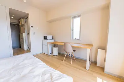 a bedroom with a desk and a chair in a room at unito residence IKEBUKURO in Tokyo