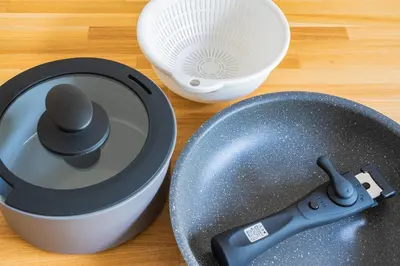 a mortar and pestle next to a plate and a whisk at unito residence IKEBUKURO in Tokyo