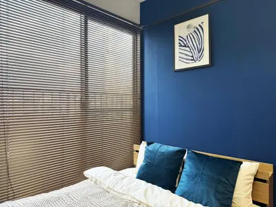 a bedroom with blue walls and a bed with blue pillows at All room Skytree view hotel-Near Ryukoku,Asakusa,kinshicho in Tokyo