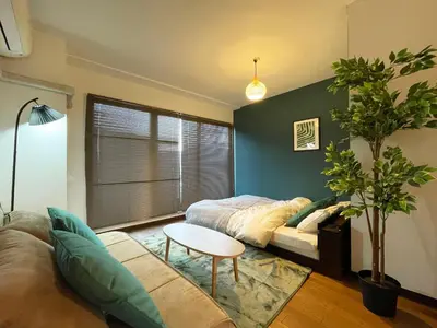 a living room with a bed and a table at All room Skytree view hotel-Near Ryukoku,Asakusa,kinshicho in Tokyo