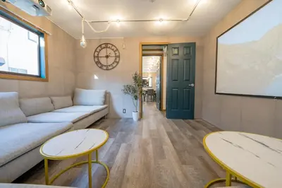 a living room with a couch and two tables at 2 shower rooms #Shinjuku 5 min walk from station ,projector in Tokyo