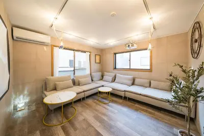 a living room with a couch and a table at 2 shower rooms #Shinjuku 5 min walk from station ,projector in Tokyo
