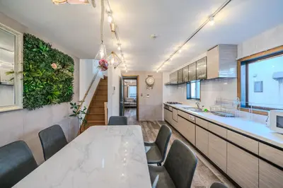 a kitchen with a long table and chairs at 2 shower rooms #Shinjuku 5 min walk from station ,projector in Tokyo