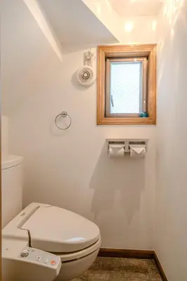 a white bathroom with a toilet and a window at 2 shower rooms #Shinjuku 5 min walk from station ,projector in Tokyo