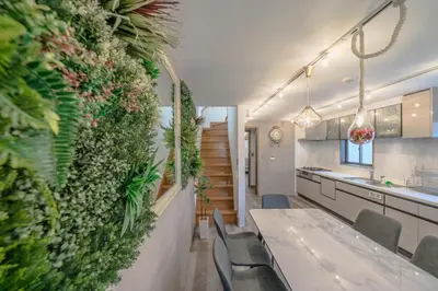 a kitchen with a green wall with a table and chairs at 2 shower rooms #Shinjuku 5 min walk from station ,projector in Tokyo