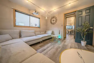 a living room with a couch and a table at 2 shower rooms #Shinjuku 5 min walk from station ,projector in Tokyo