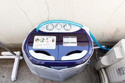 a washing machine sitting next to a wall at Mi-WIND SHINJUKU in Tokyo