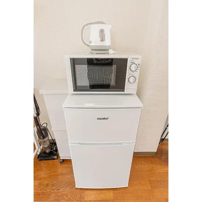 a microwave sitting on top of a white cabinet at Mi-WIND SHINJUKU in Tokyo