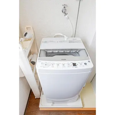 a white washing machine sitting in a room at Mi-WIND SHINJUKU in Tokyo