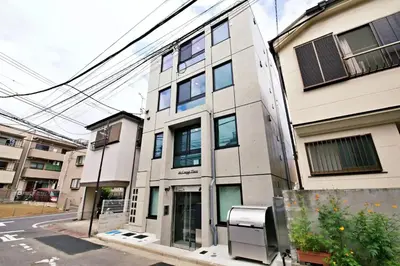 a building on a street next to a street at \u30ea\u30ea\u30cf\u30a6\u30b9\u7b39\u585a in Tokyo