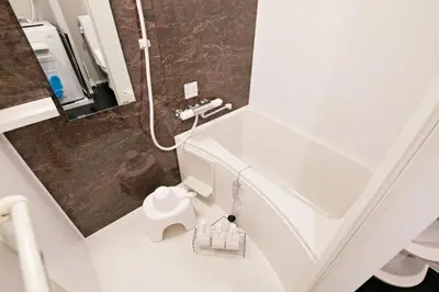 a bathroom with a white sink and a shower at \u30ea\u30ea\u30cf\u30a6\u30b9\u7b39\u585a in Tokyo