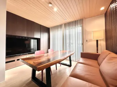 a living room with a wooden table and a couch at Zut Shinjuku House-SJ0415 in Tokyo