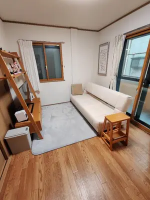 a living room with a white couch and a table at Oasis Aoto in Tokyo