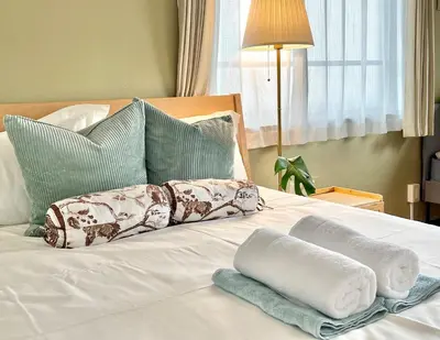 a bed with towels and pillows on it at \u65b0\u5bbf\u533a\u65e9\u7a3b\u7530\u5730\u94c16\u5206\u949f\u4e24\u5ba4\u666f\u89c2\u516c\u5bd3 in Tokyo