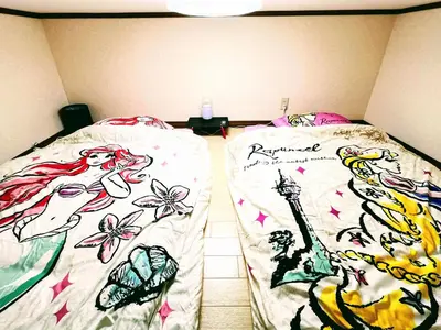 two beds with drawings of mermaids on their sheets at \u30e1\u30be\u30f3\u30af\u30ec\u30b9\u30bf in Tokyo
