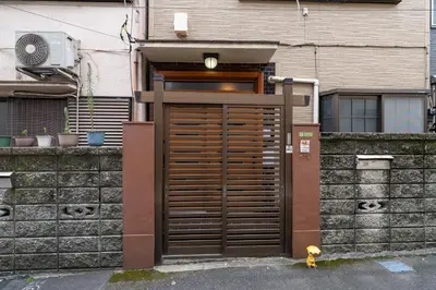 a large wooden door in front of a building at SENJU Nakacho HOUSE , \u5343\u4f4f\u4ef2\u753aHOUSE in Tokyo