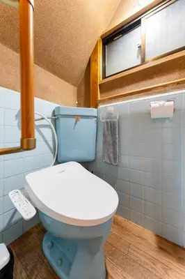 a bathroom with a white toilet and a window at SENJU Nakacho HOUSE , \u5343\u4f4f\u4ef2\u753aHOUSE in Tokyo