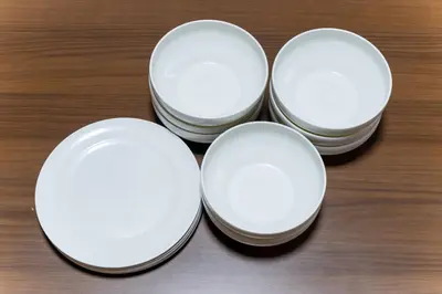 four white plates sitting on top of a table at SENJU Nakacho HOUSE , \u5343\u4f4f\u4ef2\u753aHOUSE in Tokyo