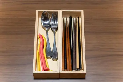 a wooden box filled with utensils on a table at SENJU Nakacho HOUSE , \u5343\u4f4f\u4ef2\u753aHOUSE in Tokyo