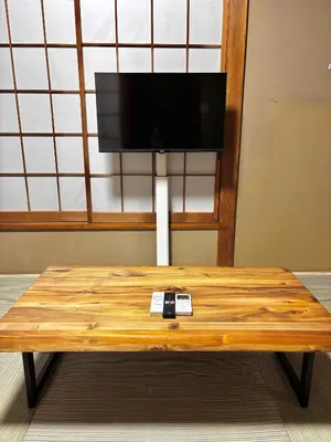 a wooden table with a tv on top of it at SENJU Nakacho HOUSE , \u5343\u4f4f\u4ef2\u753aHOUSE in Tokyo