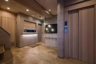 a hallway with a tv and a wall at Hotel Plantan - Adult Only in Tokyo