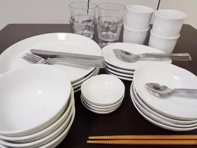 a table with white plates and silverware on it at EMILIO Nishi-Shinjuku 101,201,202 - Vacation STAY 64263v in Tokyo
