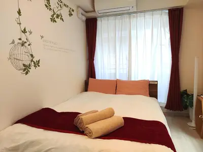 a bedroom with a bed with two towels on it at EMILIO Nishi-Shinjuku 101,201,202 - Vacation STAY 64292v in Tokyo