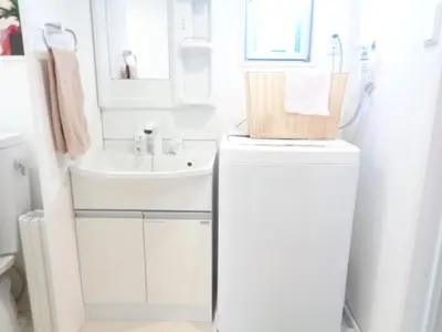 a white bathroom with a sink and a toilet at EMILIO Nishi-Shinjuku 101,201,202 - Vacation STAY 64292v in Tokyo