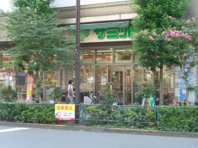 a woman walking in front of a store at EMILIO Nishi-Shinjuku 101,201,202 - Vacation STAY 64281v in Tokyo