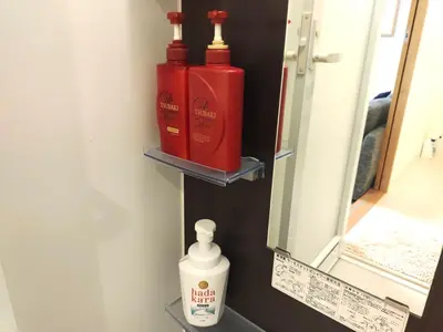 a bathroom with two bottles of soap and a mirror at EMILIO Nishi-Shinjuku 101,201,202 - Vacation STAY 64281v in Tokyo