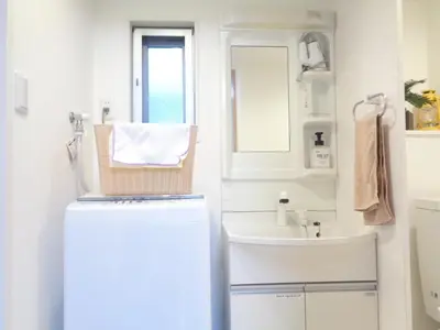 a small bathroom with a sink and a refrigerator at EMILIO Nishi-Shinjuku 101,201,202 - Vacation STAY 64281v in Tokyo