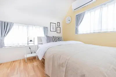a bedroom with a bed and two windows at HOTEL Y's HOUSE - Vacation STAY 66523v in Tokyo
