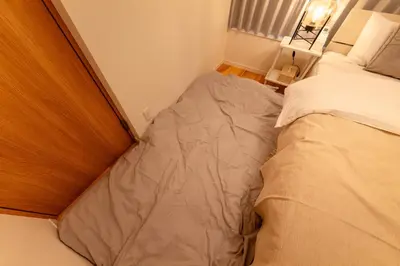 a small bedroom with a bed in the corner at HOTEL Y's HOUSE - Vacation STAY 66523v in Tokyo