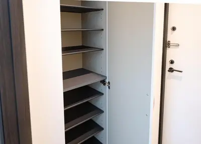 a closet with white doors and shelves at Hotel the World Omori in Tokyo