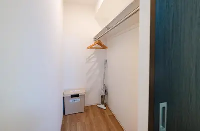 a hallway with a room with a door and a trash can at Hotel the World Omori in Tokyo