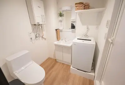 a small bathroom with a toilet and a sink at Hotel the World Omori in Tokyo