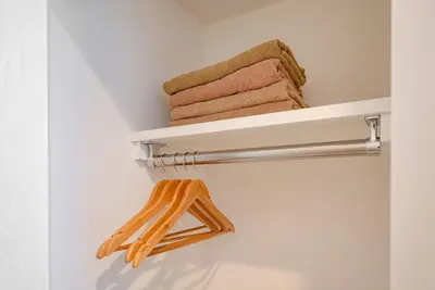 a towel rack in a bathroom with towels at Hotel the World Omori in Tokyo