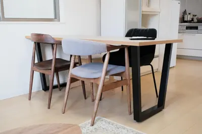 a dining room table with four chairs around it at 100㎡ Cozy Villa in Shinjuku｜JR Shin-Ōkubo Sta. 7mins. in Tokyo