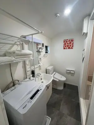 a white bathroom with a sink and a toilet at One Point Five in Tokyo